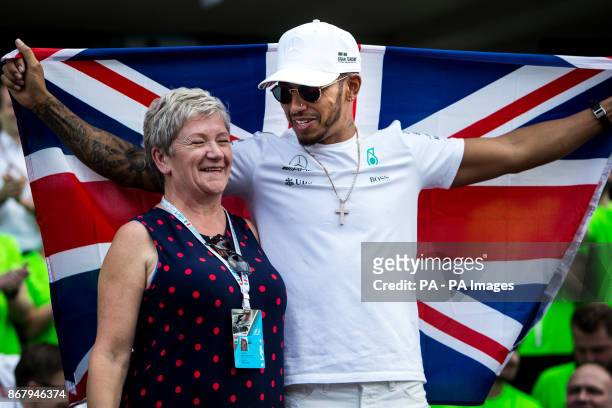 Mercedes' Lewis Hamilton celebrates winning the Formula One drivers' championship with him mum Carmen Larbalestier after the Mexican Grand Prix at...