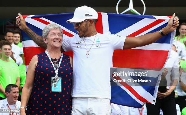 Lewis Hamilton of Great Britain and Mercedes GP celebrates with his mother Carmen Larbalestier after winning his fourth F1 World Drivers Championship...