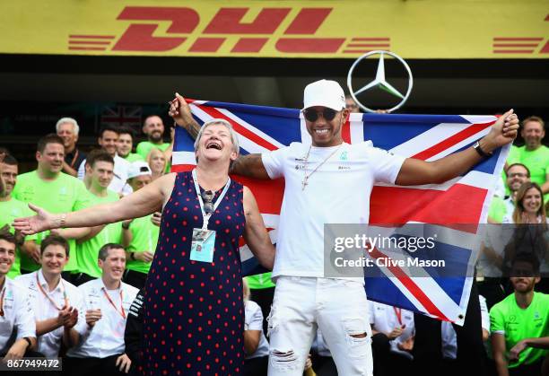 Lewis Hamilton of Great Britain and Mercedes GP celebrates with his mother Carmen Larbalestier after winning his fourth F1 World Drivers Championship...