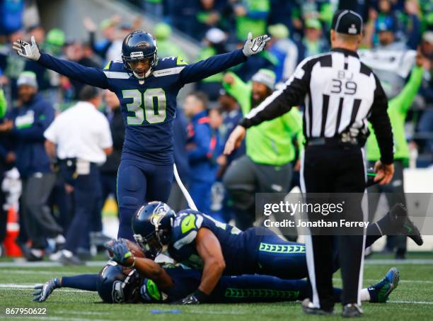 Free safety Bradley McDougald of the Seattle Seahawks walks over to celebrate the interception by Richard Sherman during the fourth quarter of the...