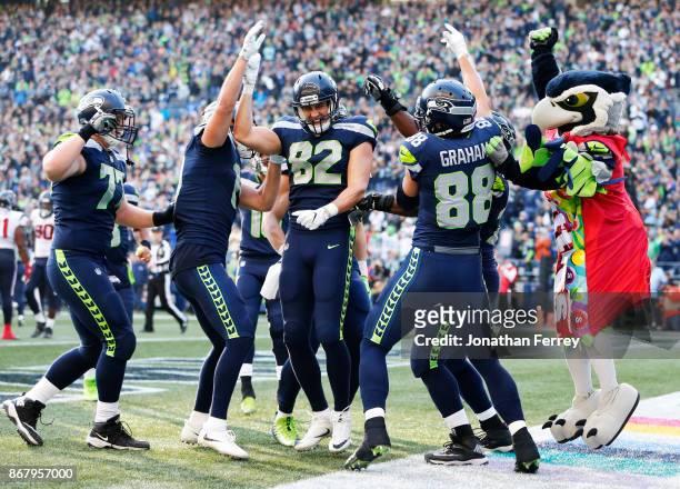 The Seattle Seahawks, including Luke Willson and mascot Blitz celebrate a 1 yard touchdown by tight end Jimmy Graham during the fourth quarter of the...