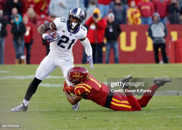 Running back Kyle Hicks of the TCU Horned Frogs is tackled by defensive back D'Andre Payne of the Iowa State Cyclones as he rushed for yards in the...