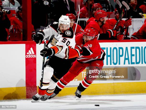 Marcus Kruger of the Carolina Hurricanes and Antoine Vermette of the Anaheim Ducks battle for the loose puck during an NHL game on October 29, 2017...