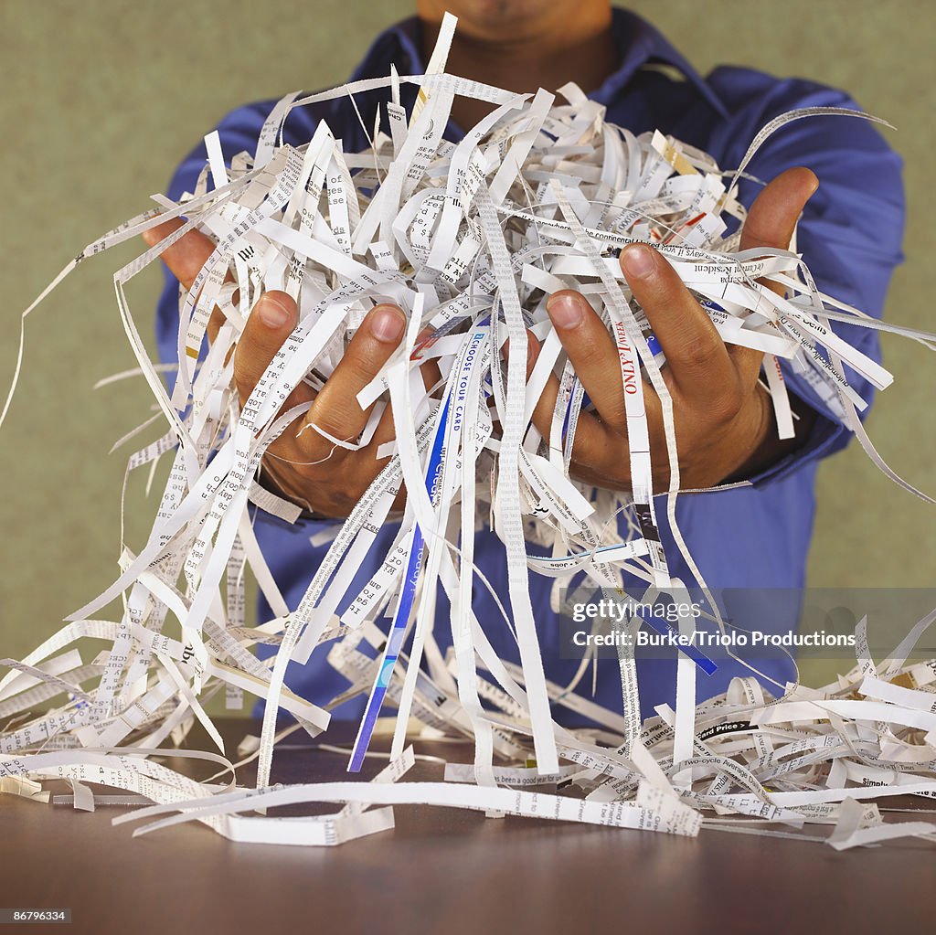 Man holding paper shreds