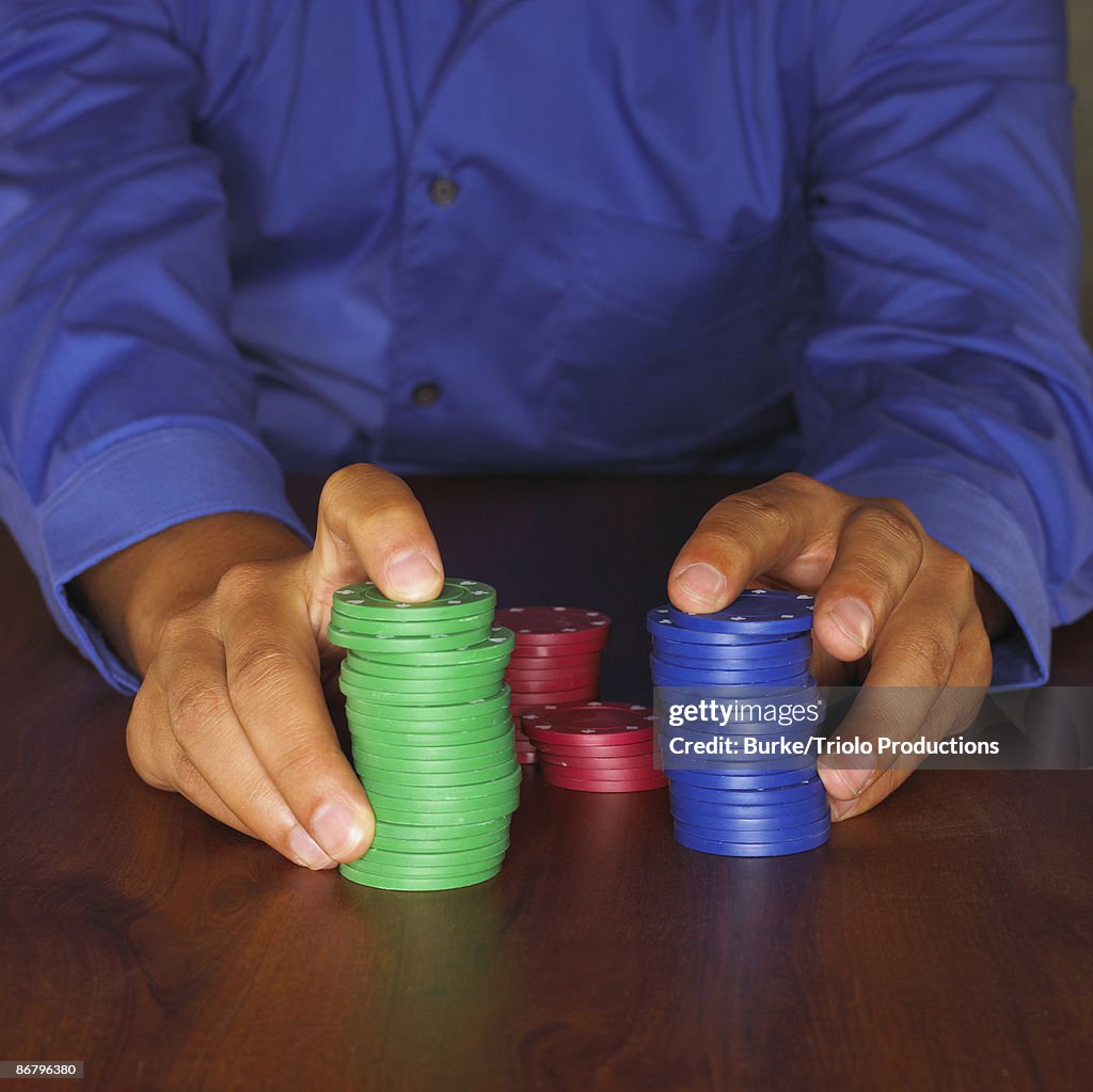 Man stacking poker chips