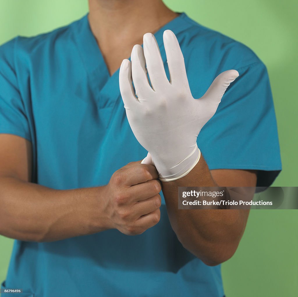 Putting on surgical glove