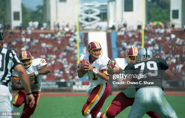 Mark Rypien of the Washington Redskins looks to pass against the Los Angeles Raiders at the Coliseum circa 1992 in Los Angeles,California.