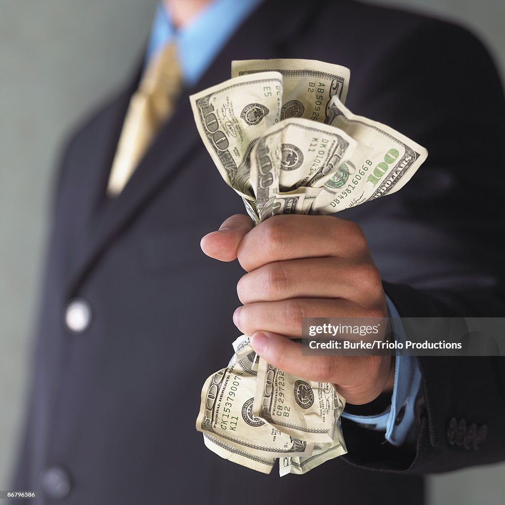 Man's hand holding cash