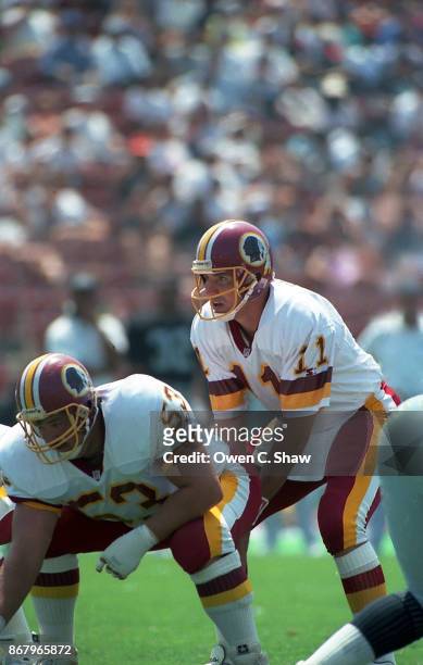 Mark Rypien of the Washington Redskins prepares to take the snap against the Los Angeles Raiders at the Coliseum circa 1992 in Los Angeles,California.