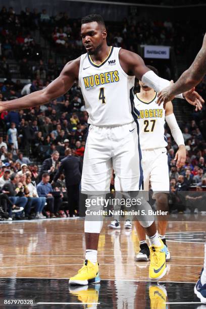 Paul Millsap of the Denver Nuggets gives high five to teammates during the game against the Brooklyn Nets on October 29, 2017 at Barclays Center in...