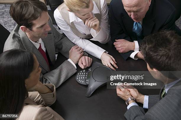 businesspeople teleconferencing - conference phone stock pictures, royalty-free photos & images