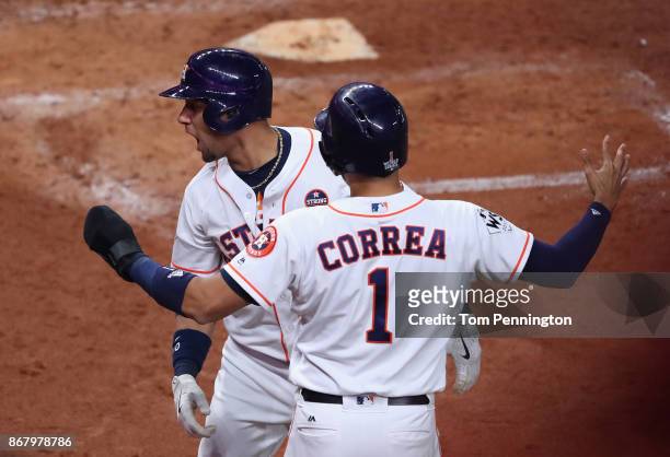 Yuli Gurriel of the Houston Astros celebrates with Carlos Correa after hitting a three run home run during the fourth inning against the Los Angeles...