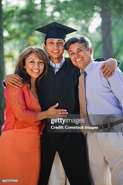 proud parents with smiling graduate - son graduation stock pictures, royalty-free photos & images
