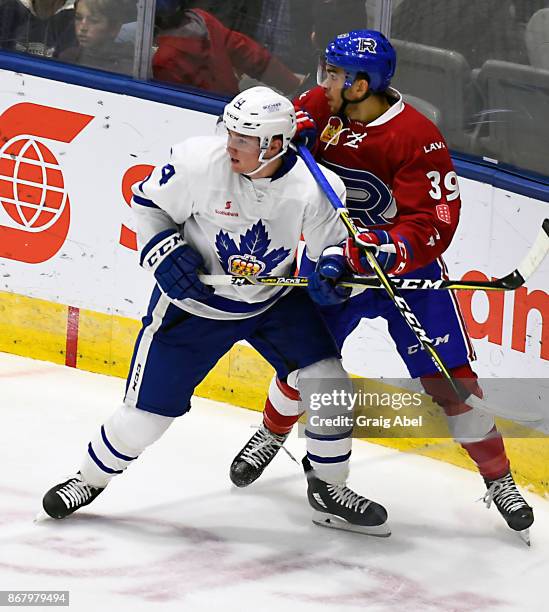 Adam Brooks of the Toronto Marlies battles with Jordan Boucher of the Laval Rocket during AHL game action on October 28, 2017 at Ricoh Coliseum in...