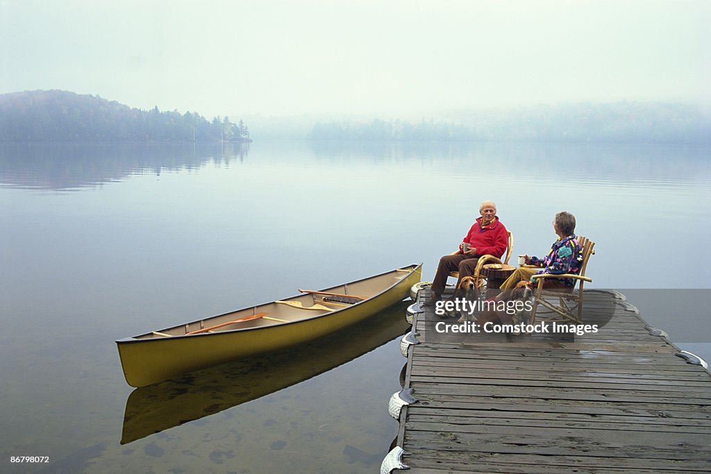 Couple relaxing on dock