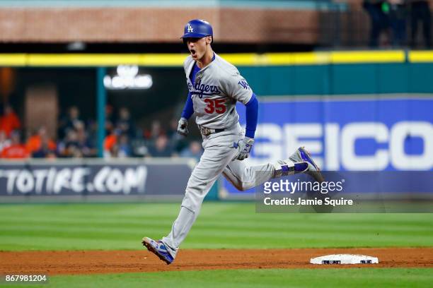 Cody Bellinger of the Los Angeles Dodgers rounds the bases after hitting a three-run home run during the fifth inning against the Houston Astros in...