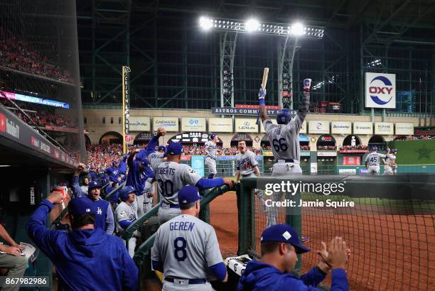 Manager Dave Roberts of the Los Angeles Dodgers celebrates with his team in the dugout after a three-run home run by Cody Bellinger during the fifth...