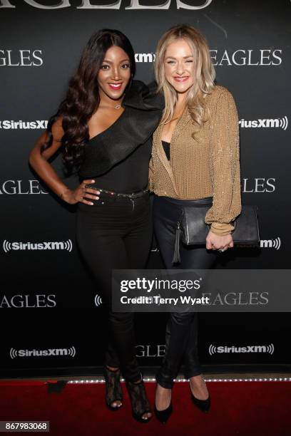 Mickey Guyton and guest attend SiriusXM presents the Eagles in their first ever concert at the Grand Ole Opry House on October 29, 2017 in Nashville,...