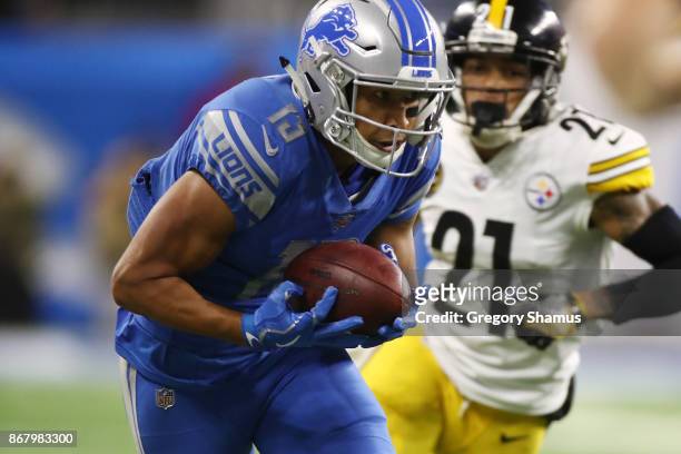 Wide receiver T.J. Jones of the Detroit Lions runs for yardage against cornerback Joe Haden of the Pittsburgh Steelers during the first half at Ford...