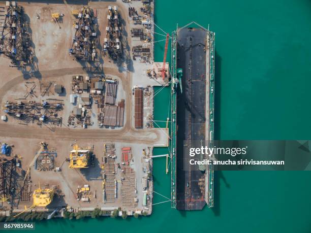 aerial view shipyard have crane machine and container ship in green sea . - floating piers ストックフォトと画像