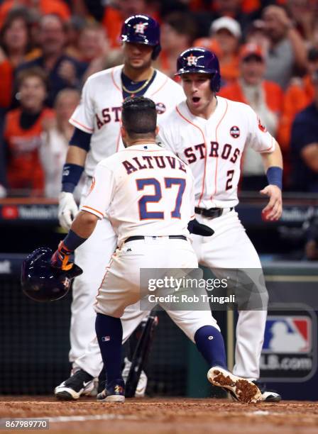 Jose Altuve of the Houston Astros celebrates with Alex Bregman after hitting a three-run home run in the fifth inning of Game 5 of the 2017 World...