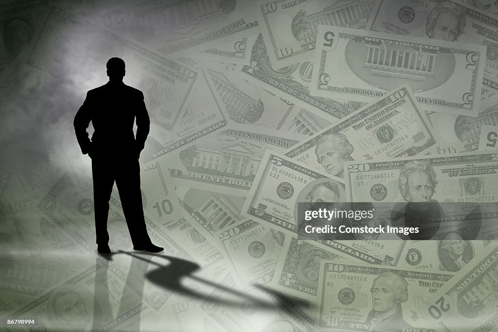 Silhouette of man with money