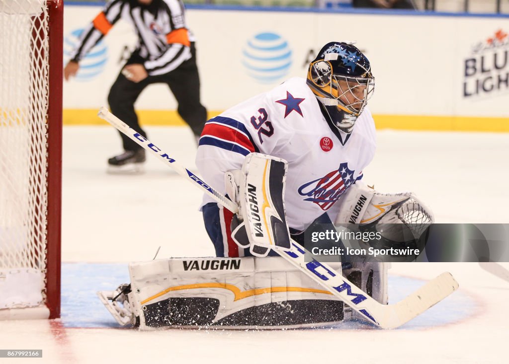 Rochester Americans goalie Adam Wilcox sticks out his glove to make a