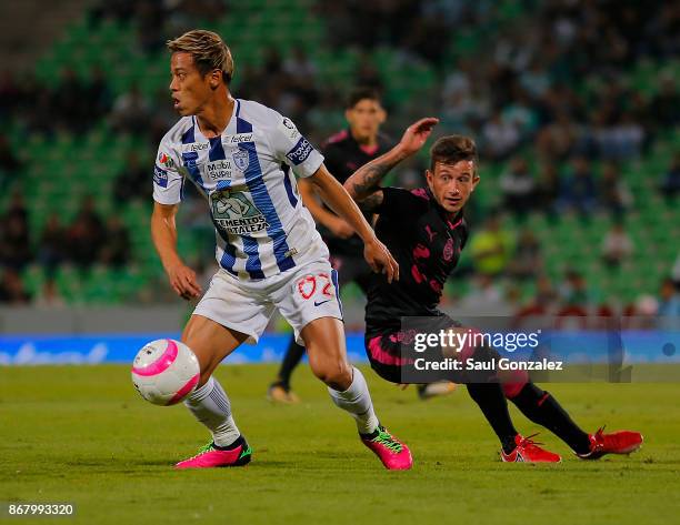 Keisuke Honda of Pachuca and Brian Lozano of Santos vie for the ball during the 15th round match between Santos Laguna and Pachuca as part of the...