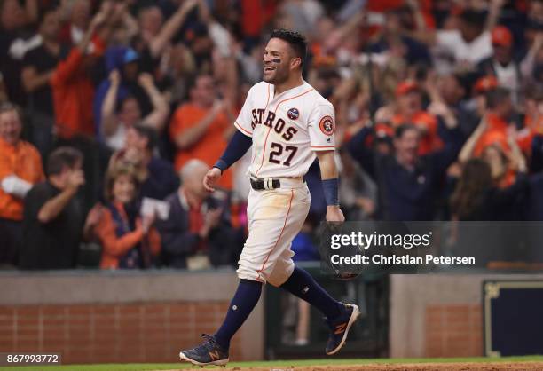 Jose Altuve of the Houston Astros celebrates after scoring on a home run by Carlos Correa during the seventh inning against the Los Angeles Dodgers...