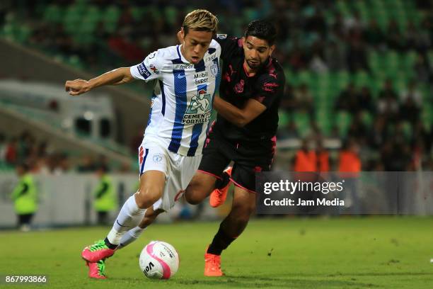 Keisuke Honda of Pachuca and Diego de Buen of Santos vie for the ball, during the 15th round match between Santos Laguna and Pachuca as part of the...