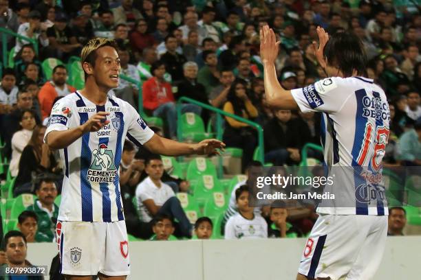 Keisuke Honda of Pachuca celebrates with teammate Jose Martinez after scoring the second goal of his team during the 15th round match between Santos...