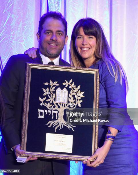 Honoree Brett Ratner accepts the Tree of Life Award from Patty Jenkins onstage during the Jewish National Fund Los Angeles Tree Of Life Dinner at...
