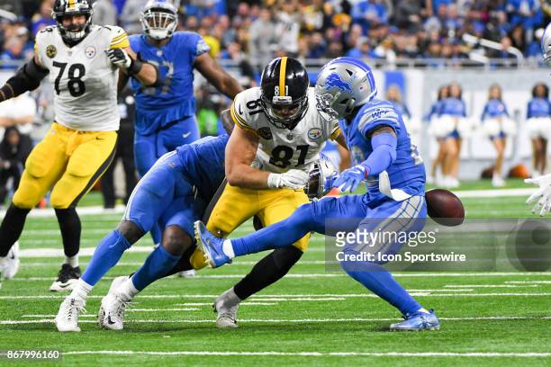 Pittsburgh Steelers tight end Jesse James is hit hard by Detroit Lions cornerback Quandre Diggs to knock the ball loose during the Detroit Lions game...