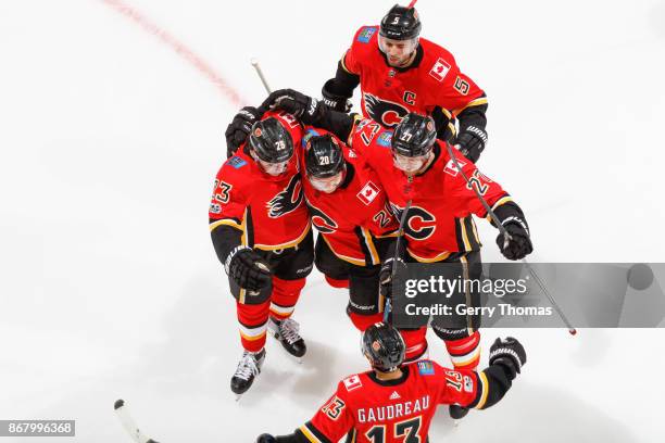 Dougie Hamilton, Johnny Gaudreau, Mark Giordano, Sean Monahan and Curtis Lazar the Calgary Flames celebrate after scoring a second goal an NHL game...