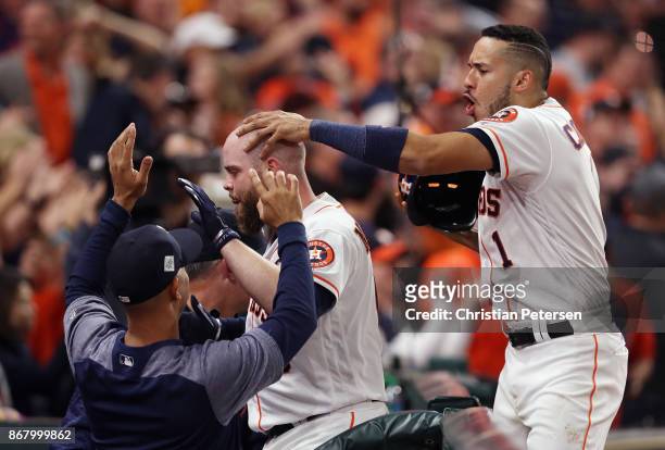 Brian McCann of the Houston Astros celebrates with teammates after hitting a solo home run during the eighth inning against the Los Angeles Dodgers...