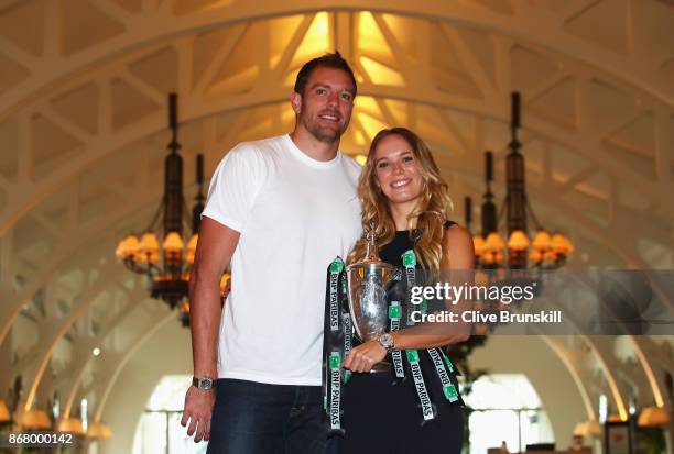 Champion Caroline Wozniacki of Denmark poses with the Billie Jean King trophy and American professional basketball player David Lee after her victory...