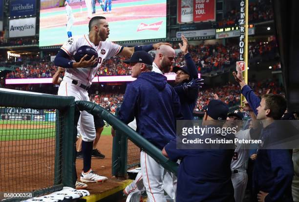 Brian McCann of the Houston Astros celebrates with teammates after hitting a solo home run during the eighth inning against the Los Angeles Dodgers...