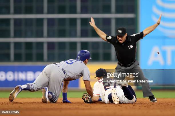 Austin Barnes of the Los Angeles Dodgers slides safely in to second base with a double as Jose Altuve of the Houston Astros attempts the tag during...