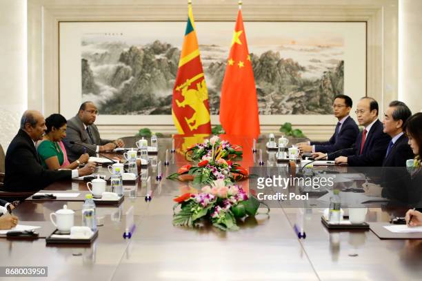 Chinese Foreign Minister Wang Yi and Sri Lanka's Foreign Minister Tilak Marapana attend a meeting at the Ministry of Foreign Affairs on October 30,...