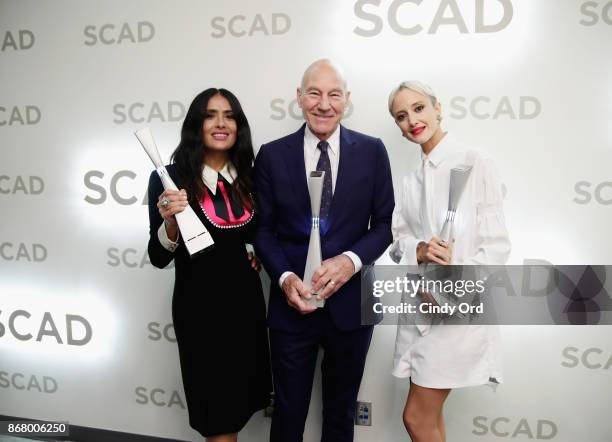 Actors Salma Hayek, Patrick Stewart, and Andrea Riseborough pose backstage with awards at Lucas Theatre during 20th Anniversary SCAD Savannah Film...