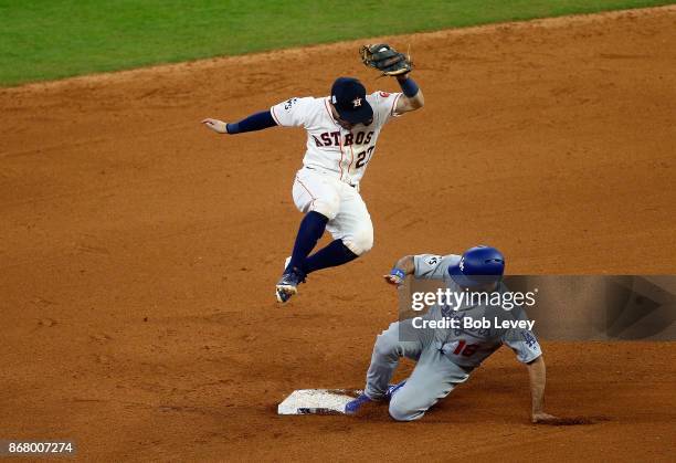 Andre Ethier of the Los Angeles Dodgers collides with Jose Altuve of the Houston Astros as he is tagged out during the tenth inning in game five of...