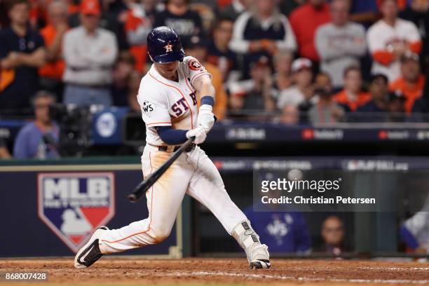 Alex Bregman of the Houston Astros hits a game-winning single during the tenth inning against the Los Angeles Dodgers in game five of the 2017 World...