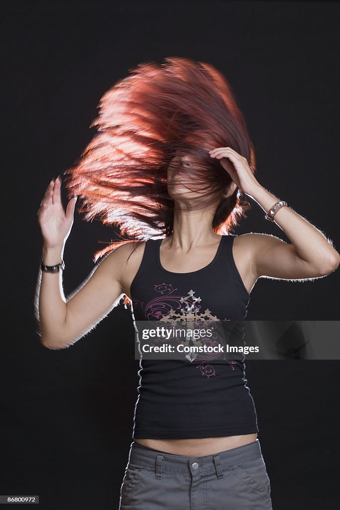 Stylish woman tossing hair back