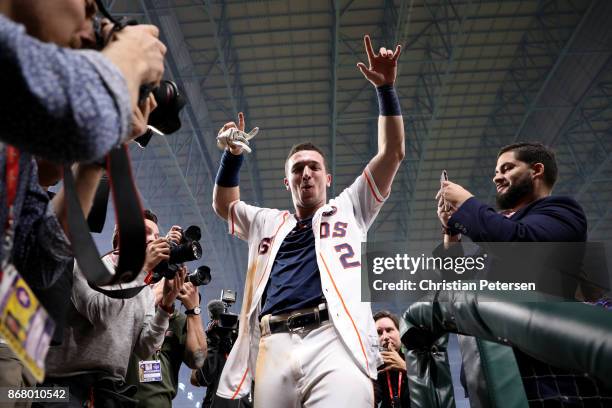 Alex Bregman of the Houston Astros celebrates after hitting the game-winning single during the tenth inning to defeat the Los Angeles Dodgers in game...