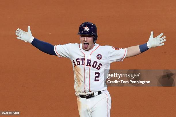 Alex Bregman of the Houston Astros celebrates after hitting a game-winning single during the tenth inning against the Los Angeles Dodgers in game...