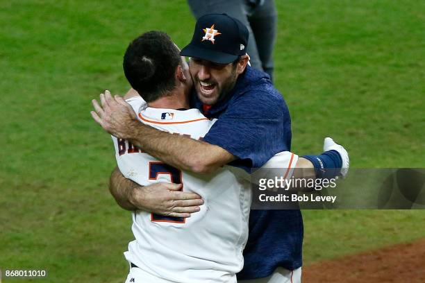 Alex Bregman of the Houston Astros celebrates with Justin Verlander after hitting the game-winning single during the tenth inning to defeat the Los...