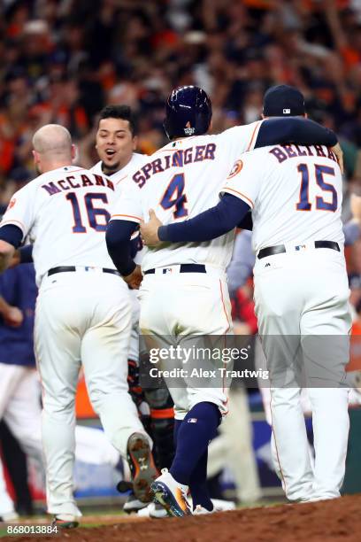 Brian McCann, George Springer, Juan Centeno and Carlos Beltran of the Houston Astros celebrate after the Astros defeated the Los Angeles Dodgers in...