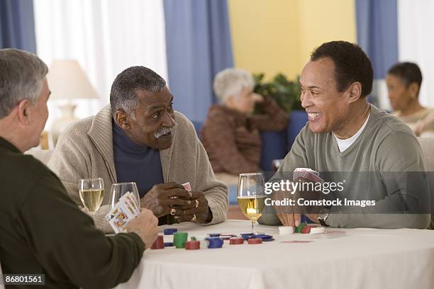 group of men playing poker - only mature men stock pictures, royalty-free photos & images