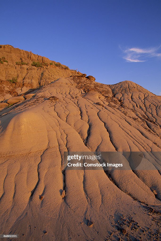 Badlands and moon at sunset