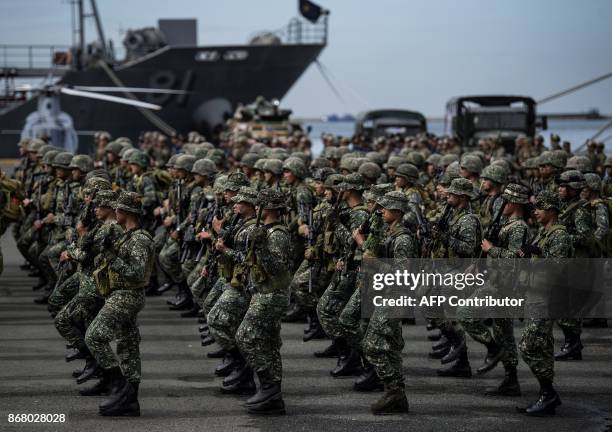 Philippine soldiers march as they arrive at the port of Manila on October 30 with some 500 personnel composed of marines, sailors, aviators and...